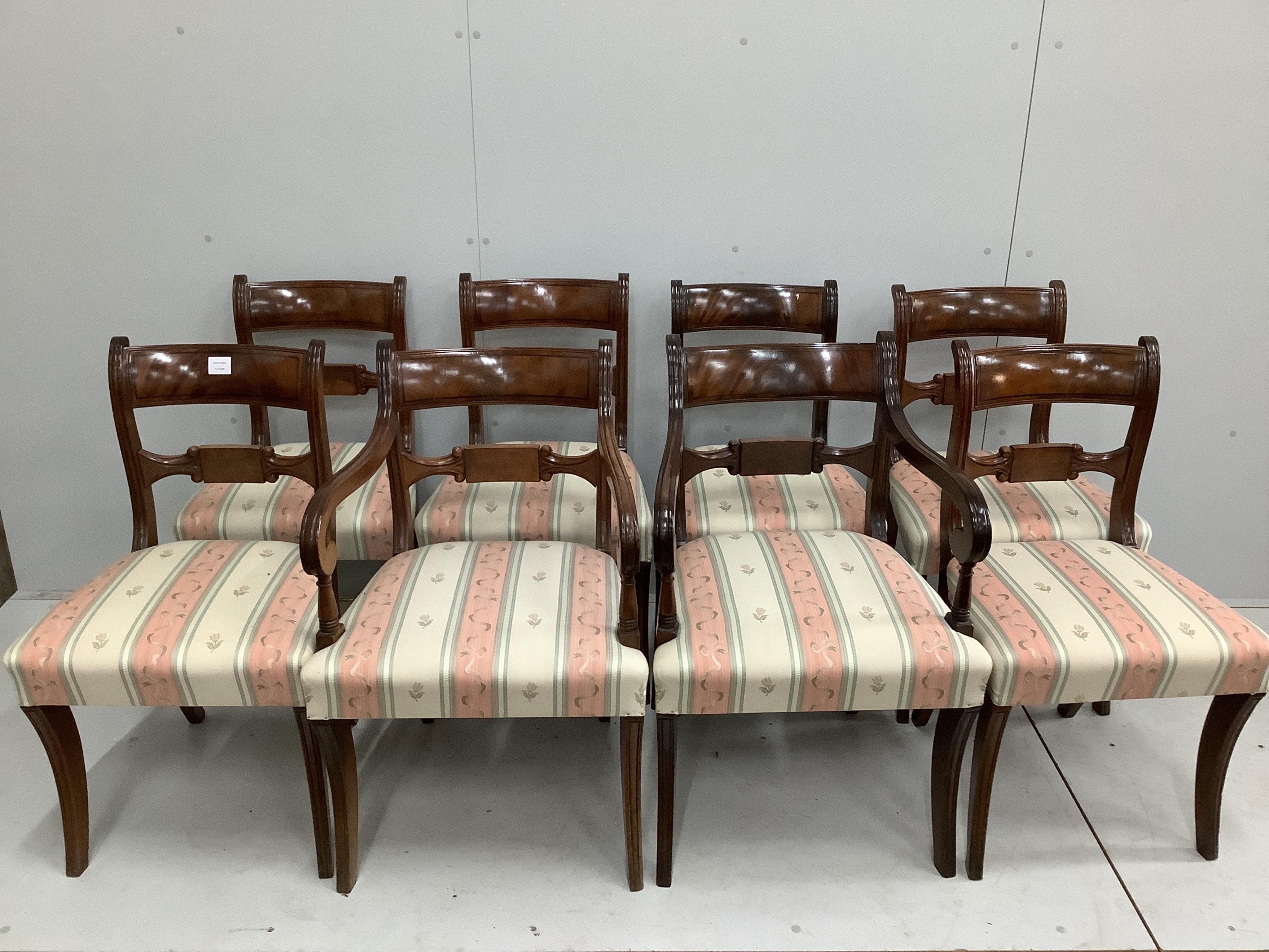 A set of eight reproduction Regency style mahogany sabre leg dining chairs, two with arms